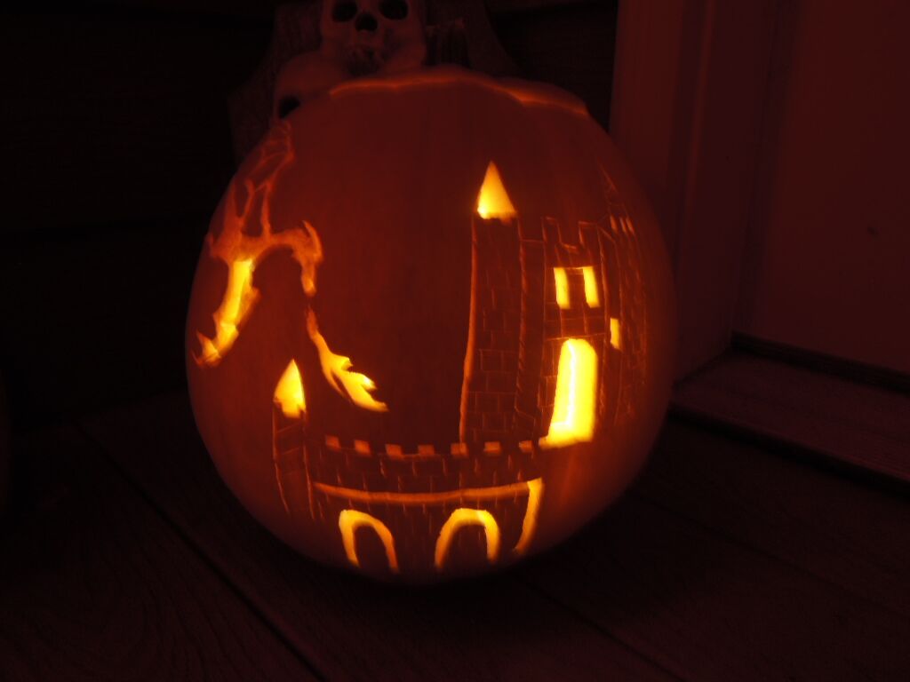 A pumpkin carved with a fire-breathing dragon.