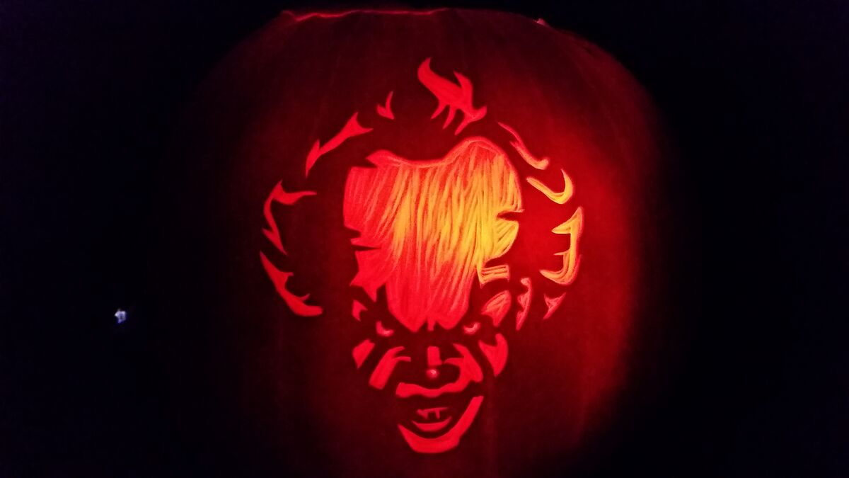 A pumpkin carved with Pennywise from It.