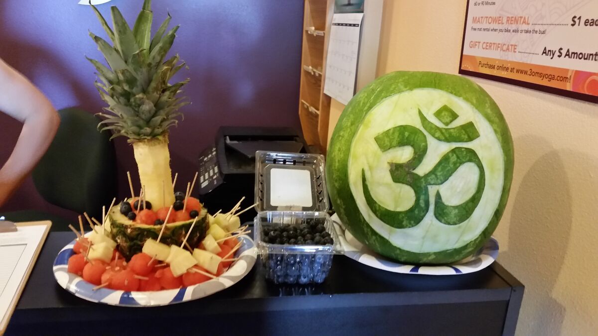 A watermelon carved with the 3 Oms Yoga design.