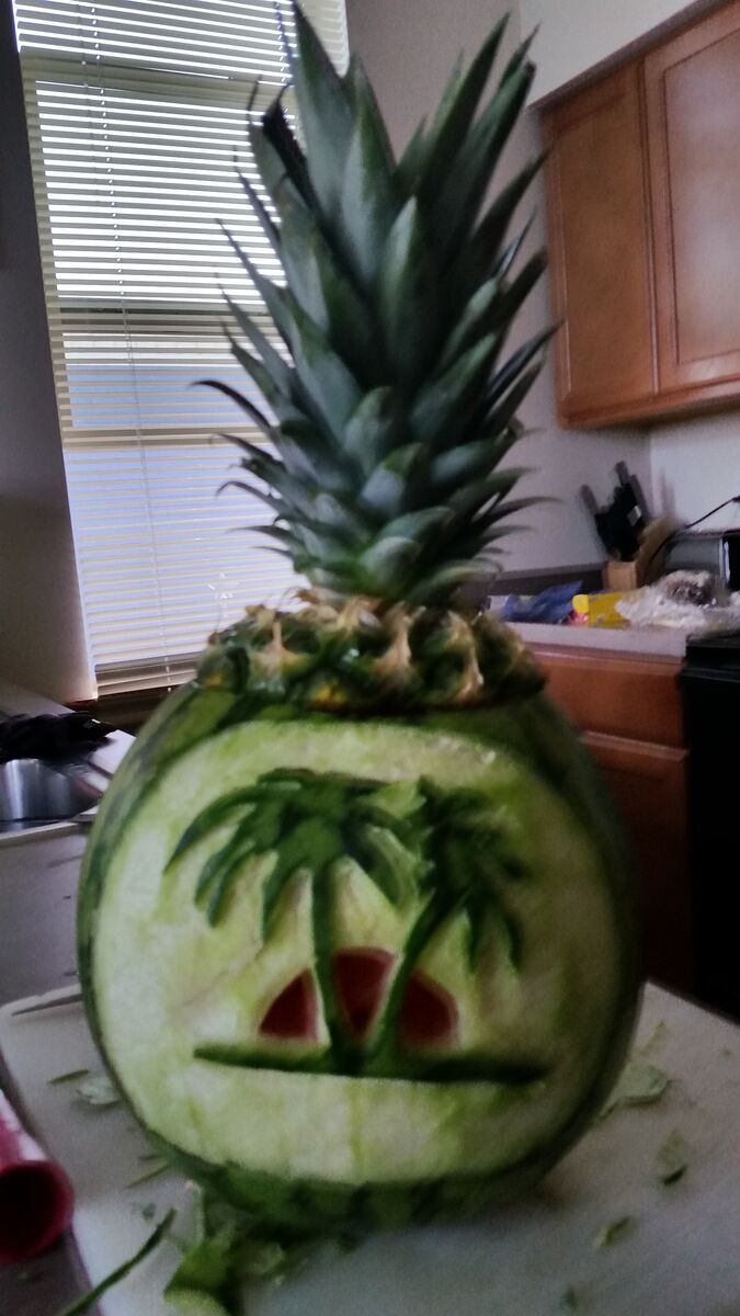 A watermelon carved with an island in the sun.