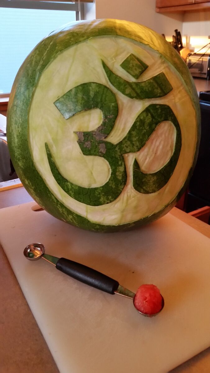 A watermelon carved with an om symbol.
