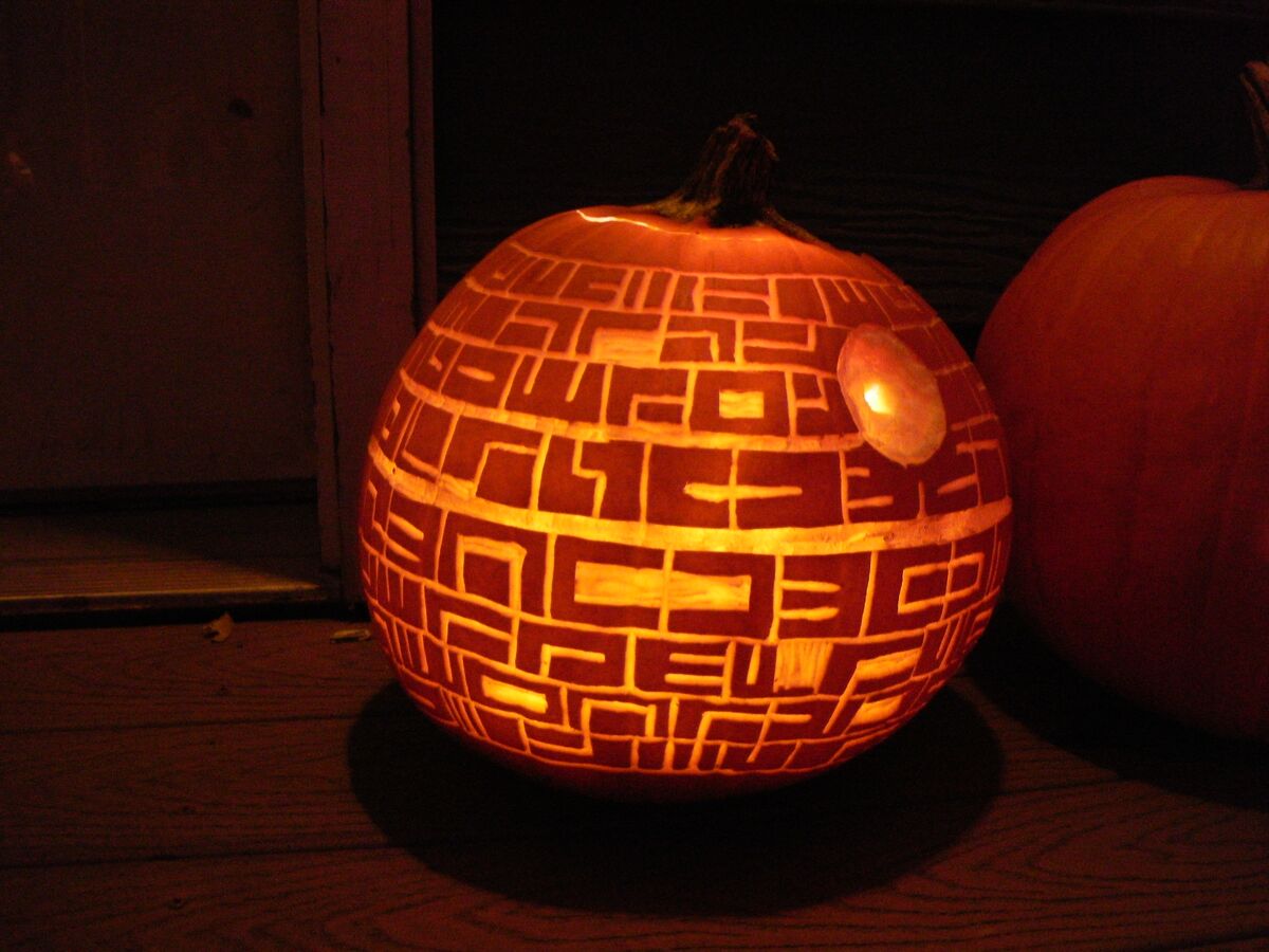 A pumpkin carved with the Death Star from Star Wars.