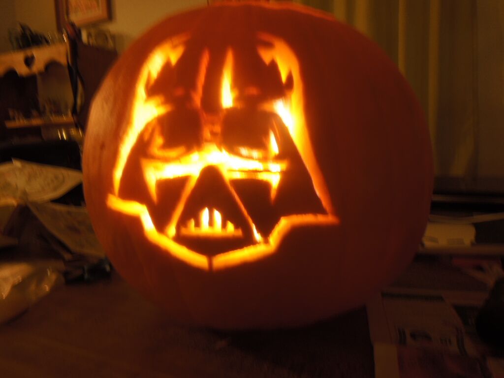 A pumpkin carved with Darth Vader from Star Wars.