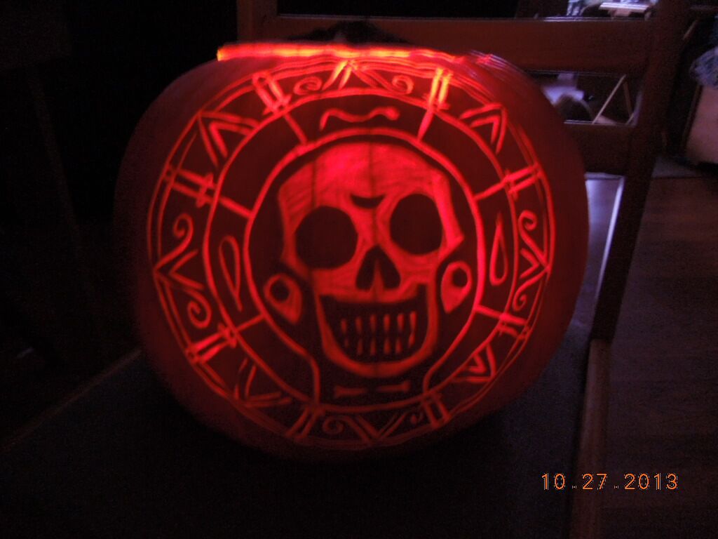 A pumpkin carved with the cursed Aztec gold medallion from Pirates of the Caribbean.