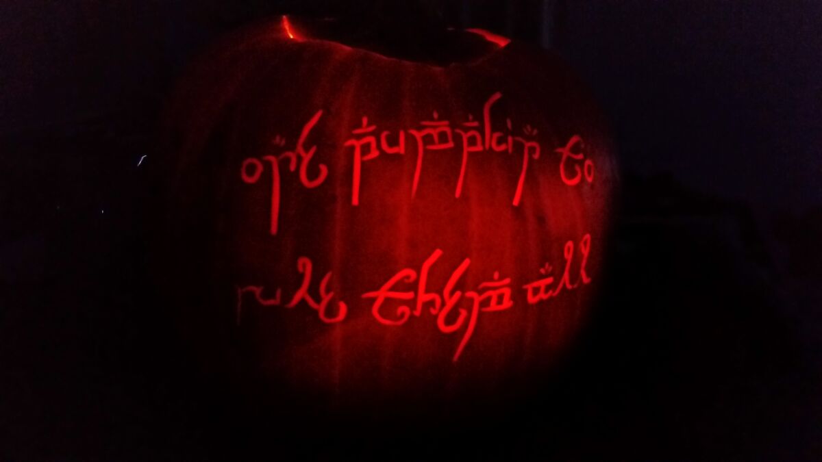 A pumpkin carved with a ring of pseudo-Tengwar lettering, after The Lord of the Rings.