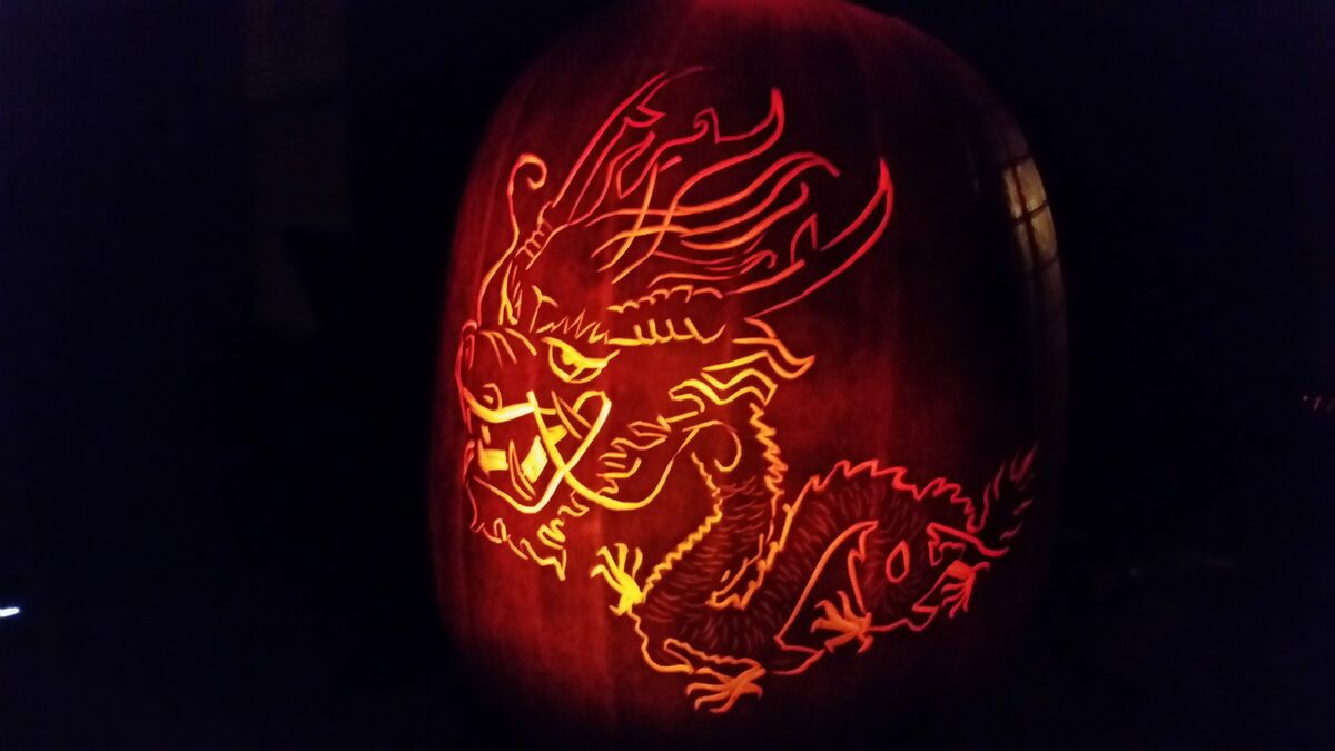 A pumpkin carved with a Chinese dragon.