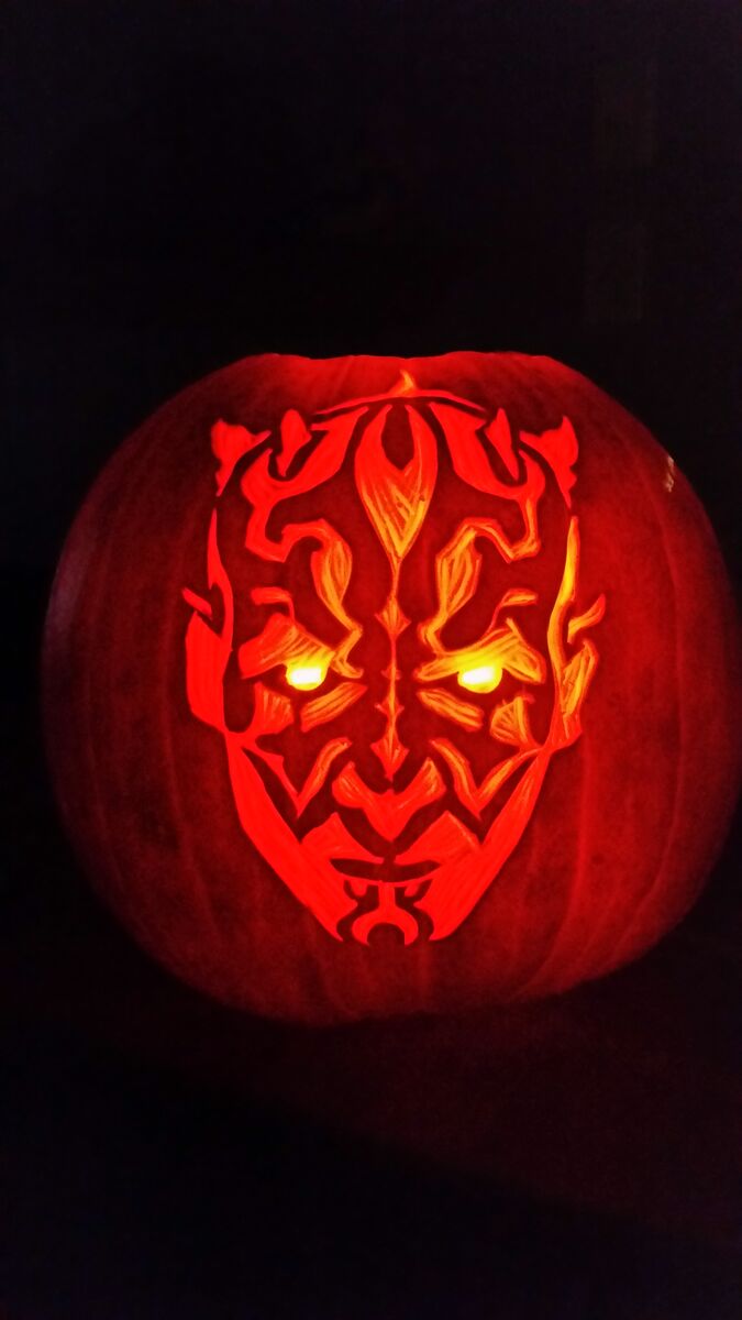 A pumpkin carved with Darth Maul from Star Wars.