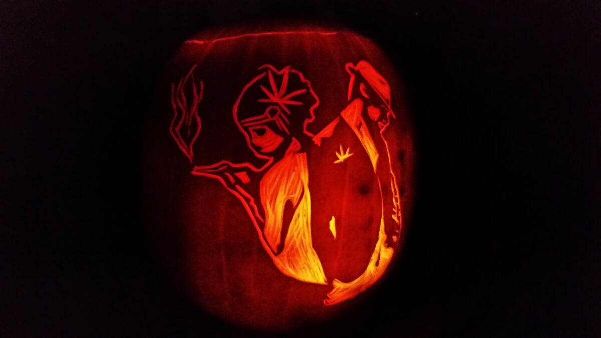 A pumpkin carved with the High Society logo.