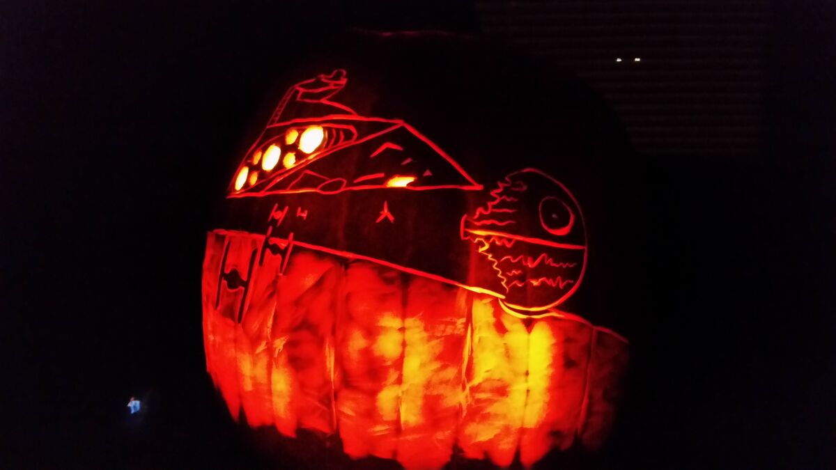 A pumpkin carved with a Star Destroyer from Star Wars.