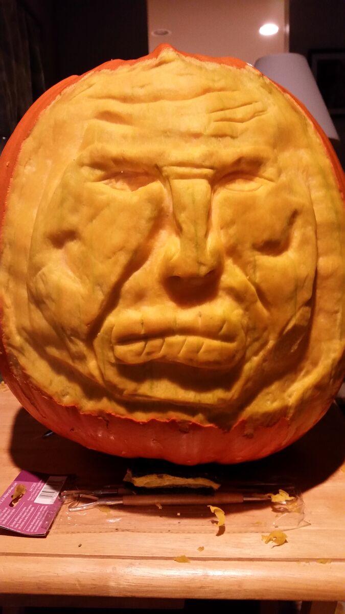 A pumpkin with a three-dimensional carving.