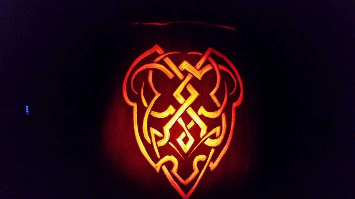 A pumpkin carved with a Celtic square knot.