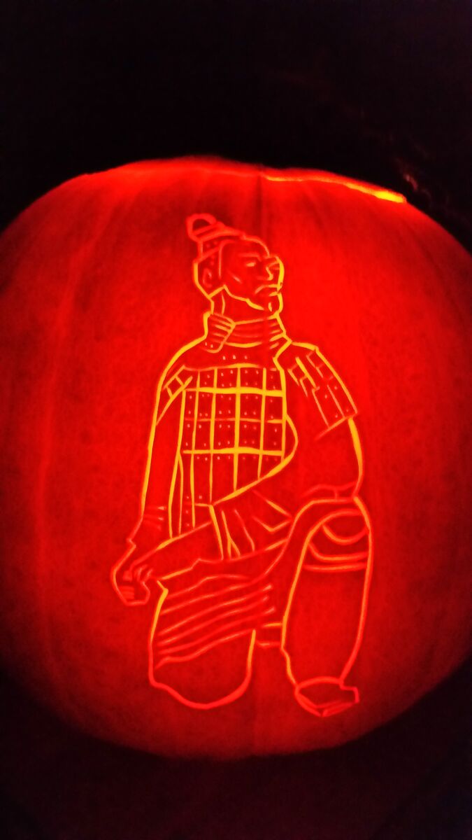A pumpkin carved with a samurai.