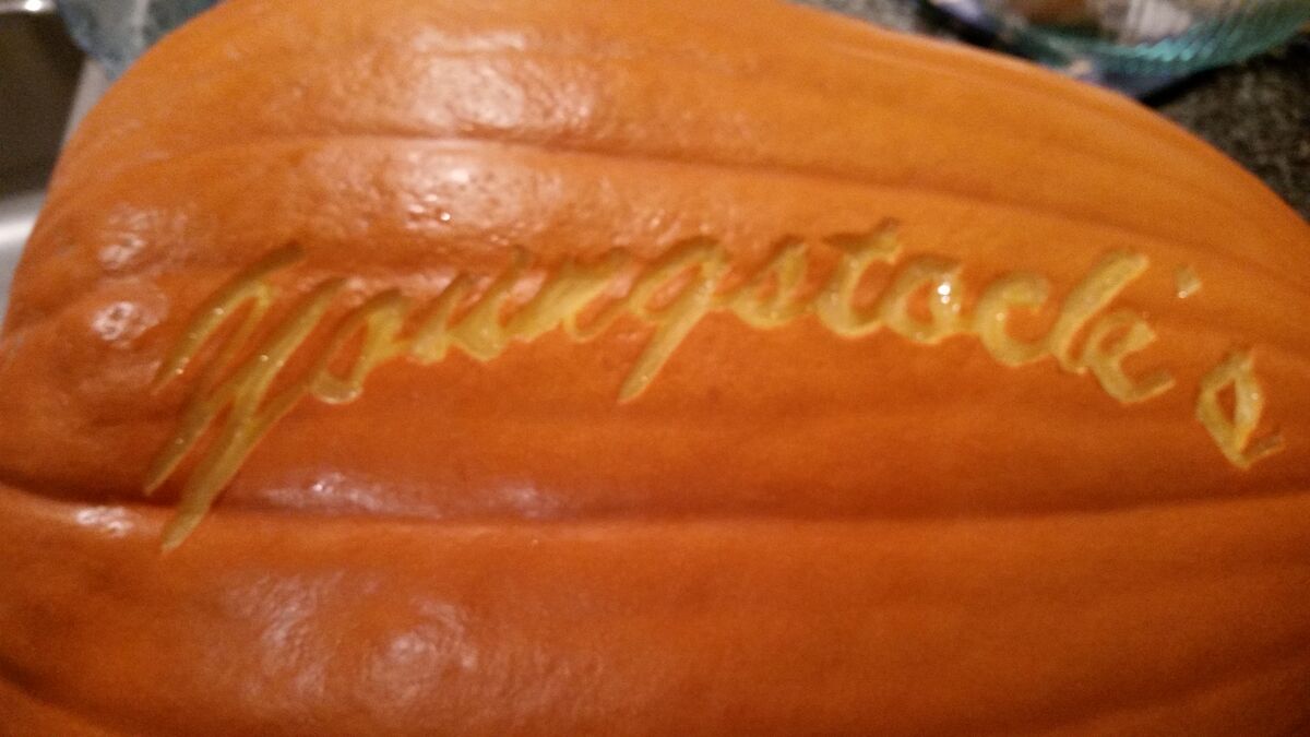 A pumpkin carved with the Youngstock's Farm logo.