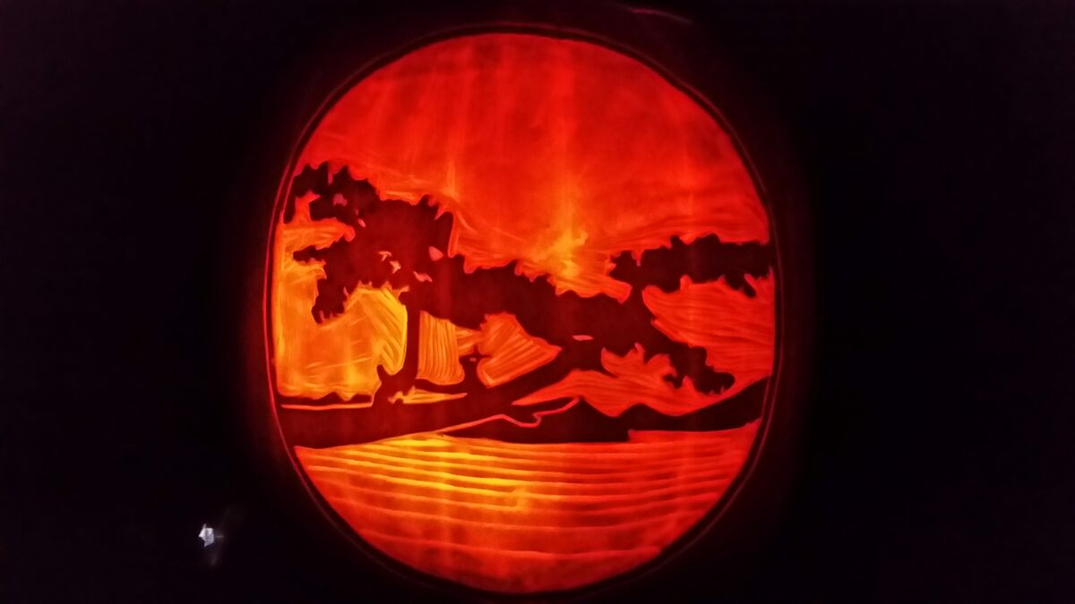 A pumpkin carved with the Proscapes logo.
