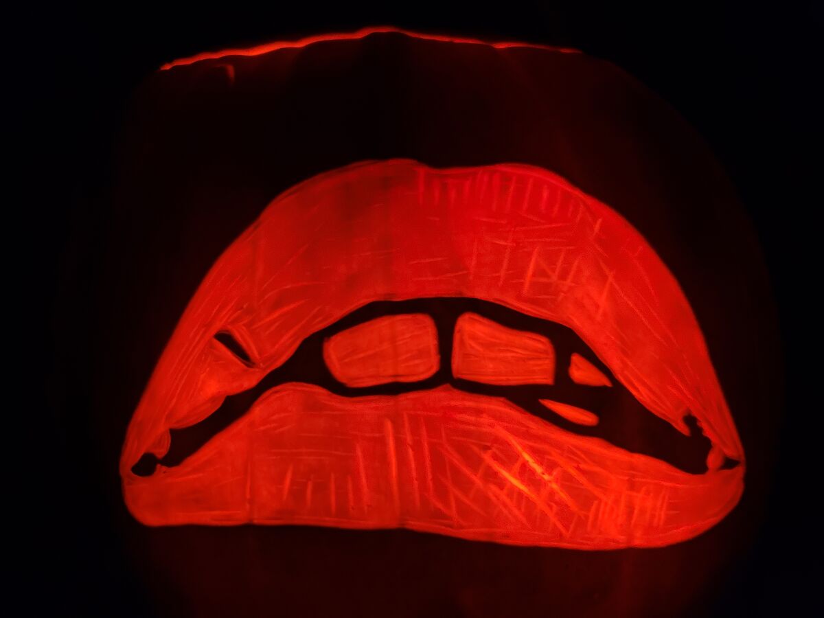 A pumpkin carved with the lips logo from The Rocky Horror Picture Show.
