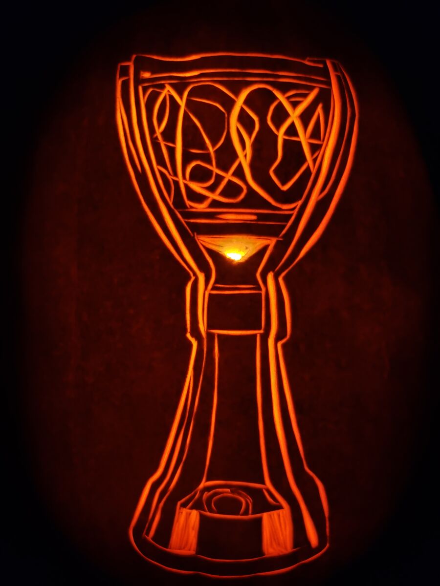A pumpkin carved with a NASCAR trophy.