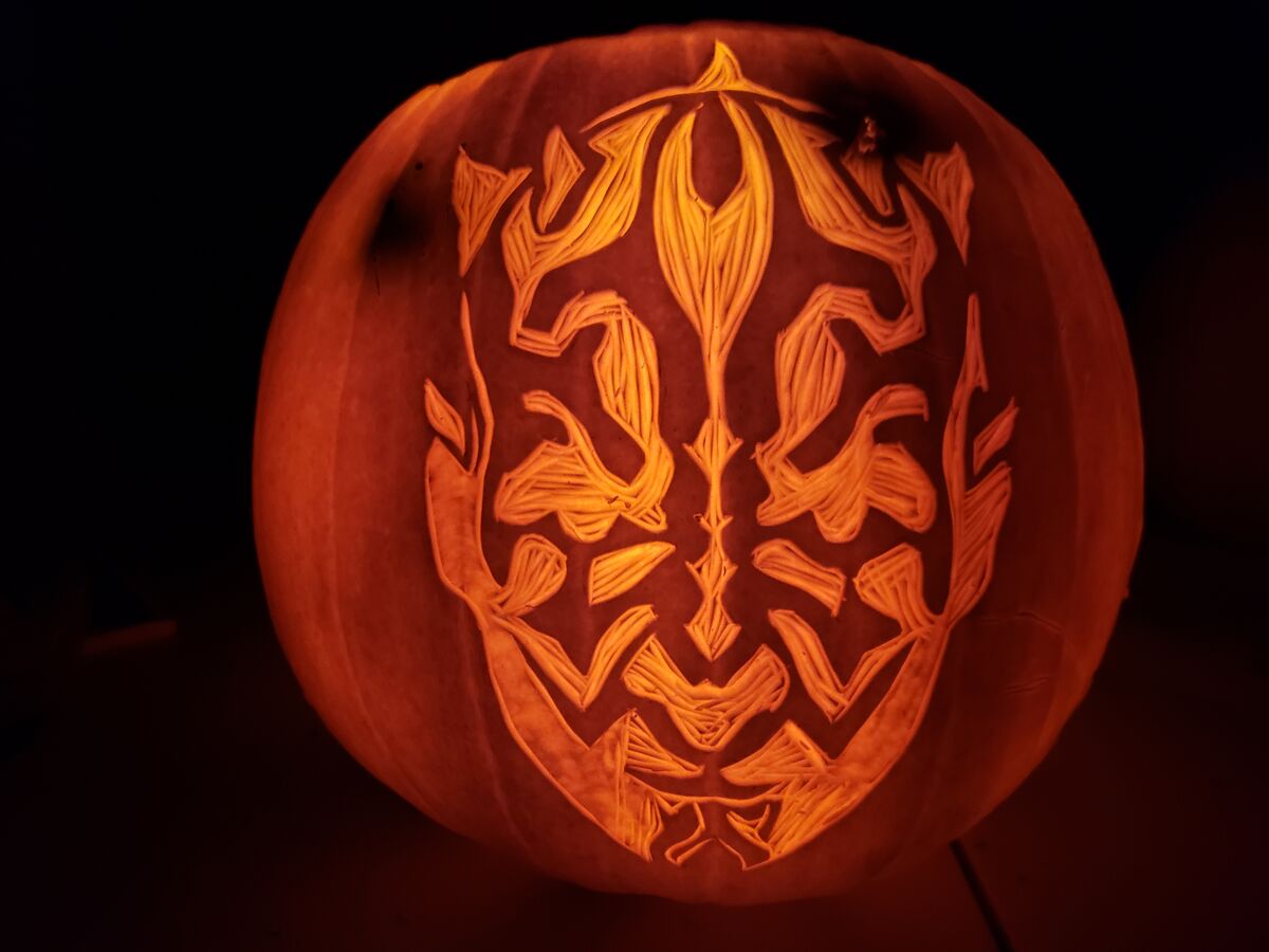 A pumpkin carved with Darth Maul from Star Wars.