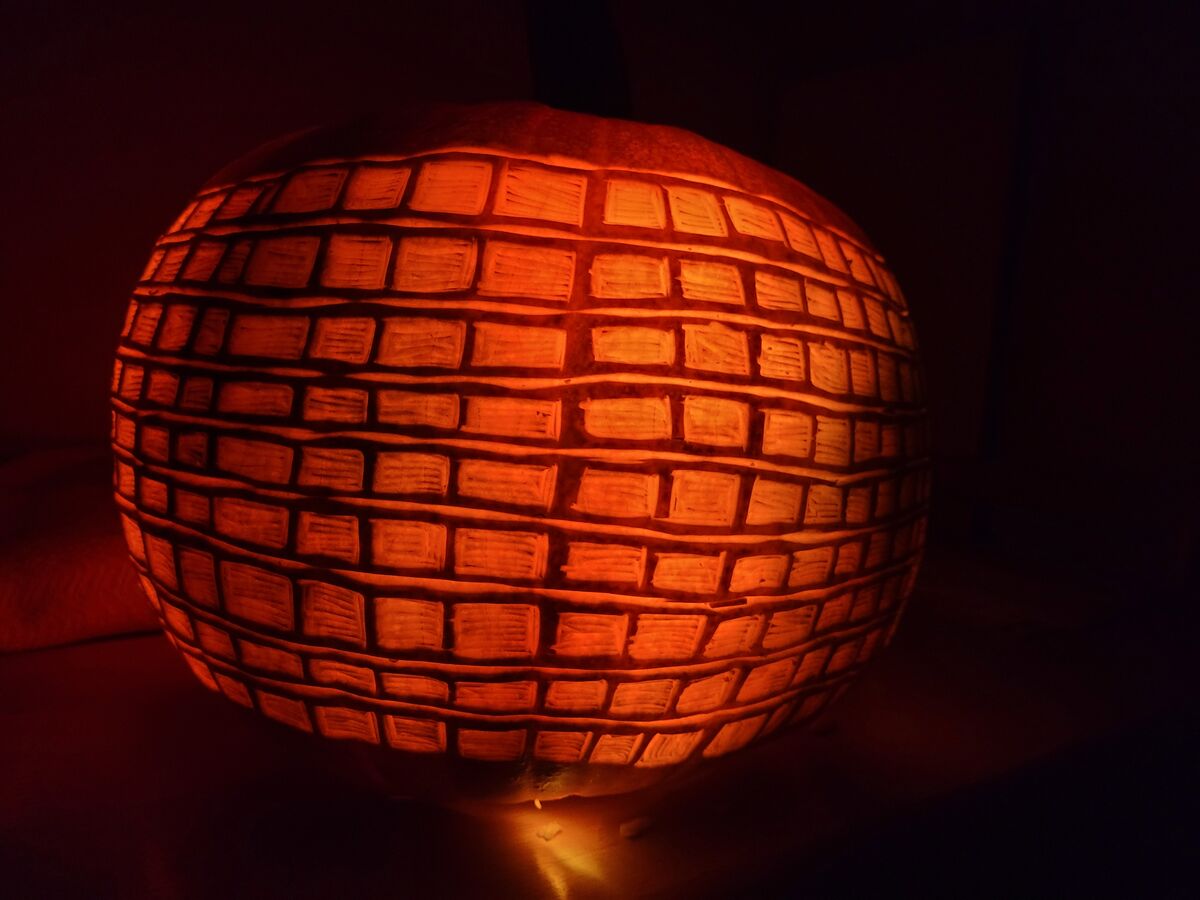 A pumpkin carved as a disco ball.
