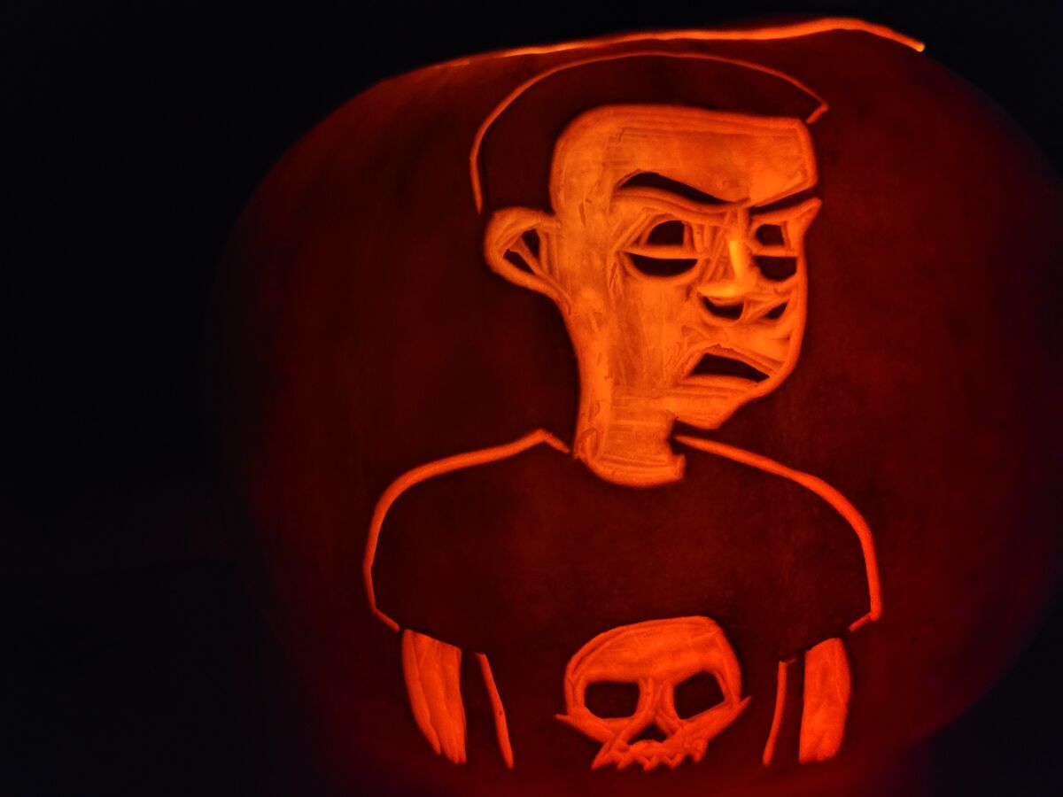 A pumpkin carved with Sid Phillips from Toy Story.