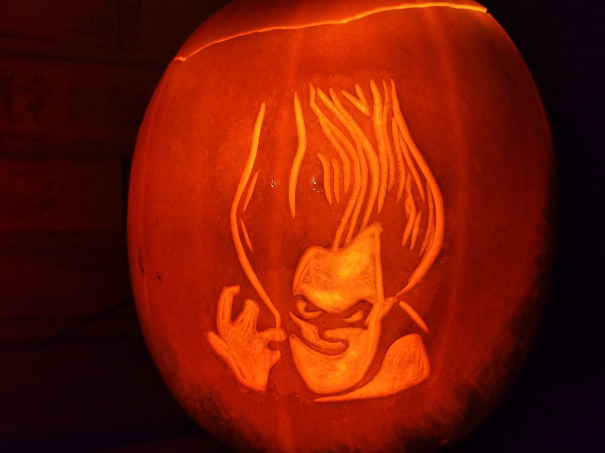 A pumpkin carved with Syndrome from The Incredibles.