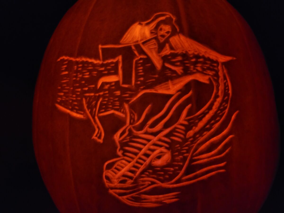 A pumpkin carved with Falkor and Atreyu from The NeverEnding Story.