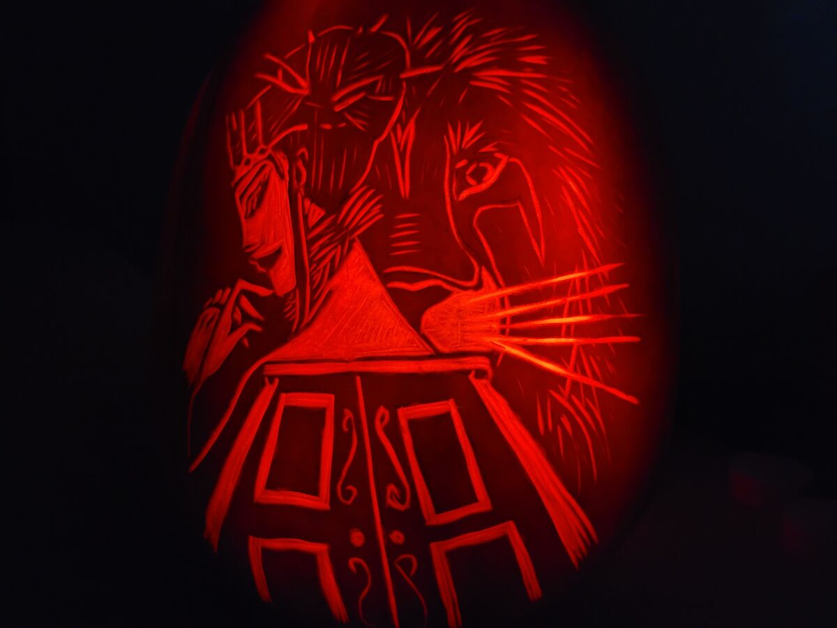 A pumpkin carved with imagery from The Lion, the Witch and the Wardrobe.