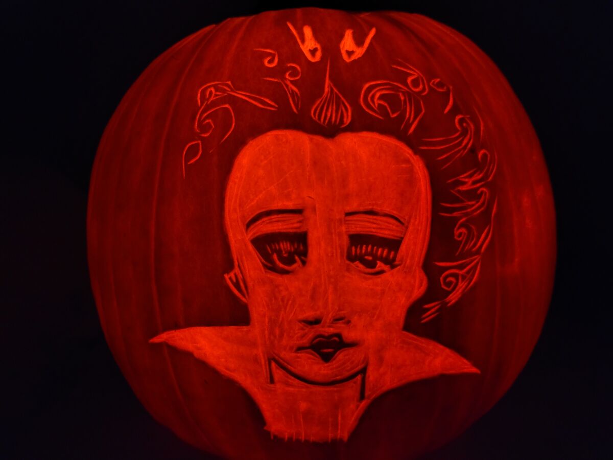 A pumpkin carved with the Queen of Hearts from Alice in Wonderland.