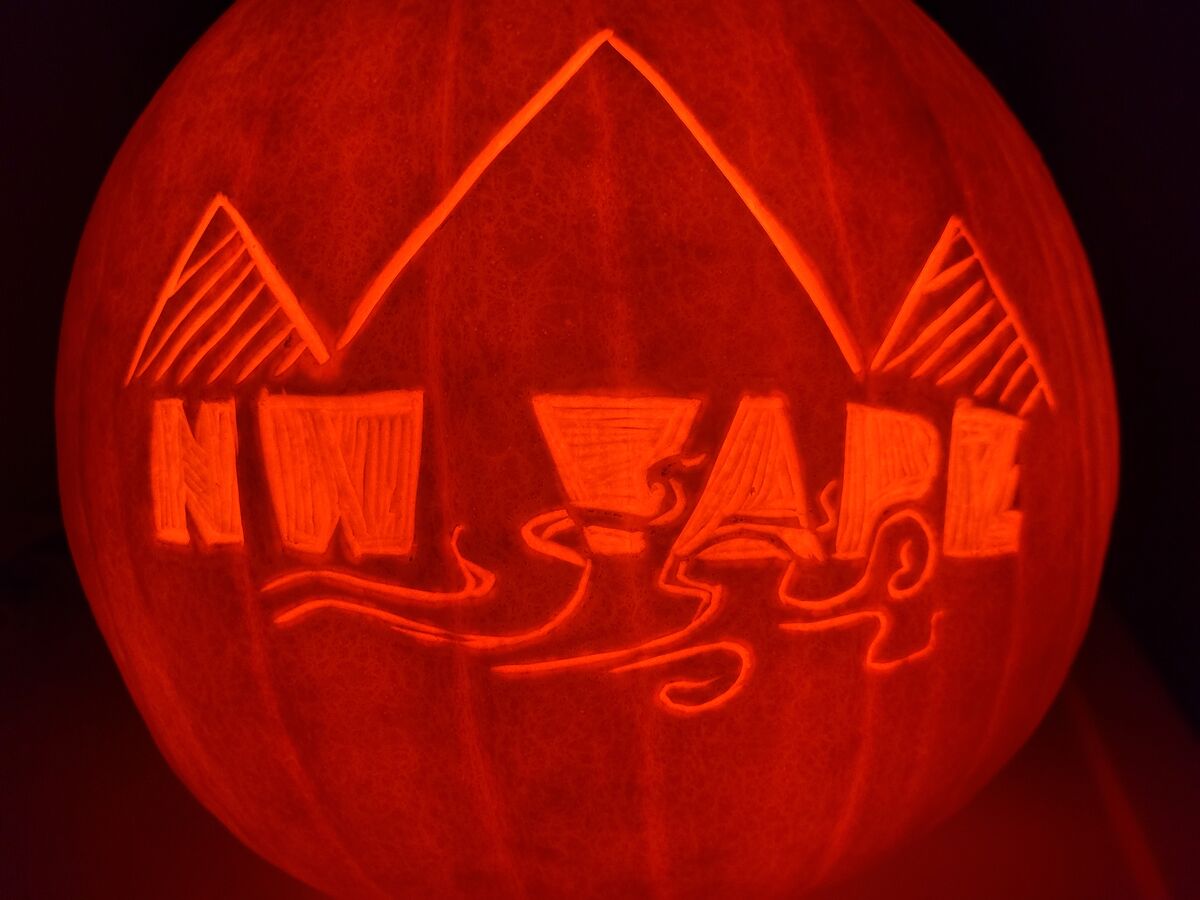 A pumpkin carved with the NW Vape logo.