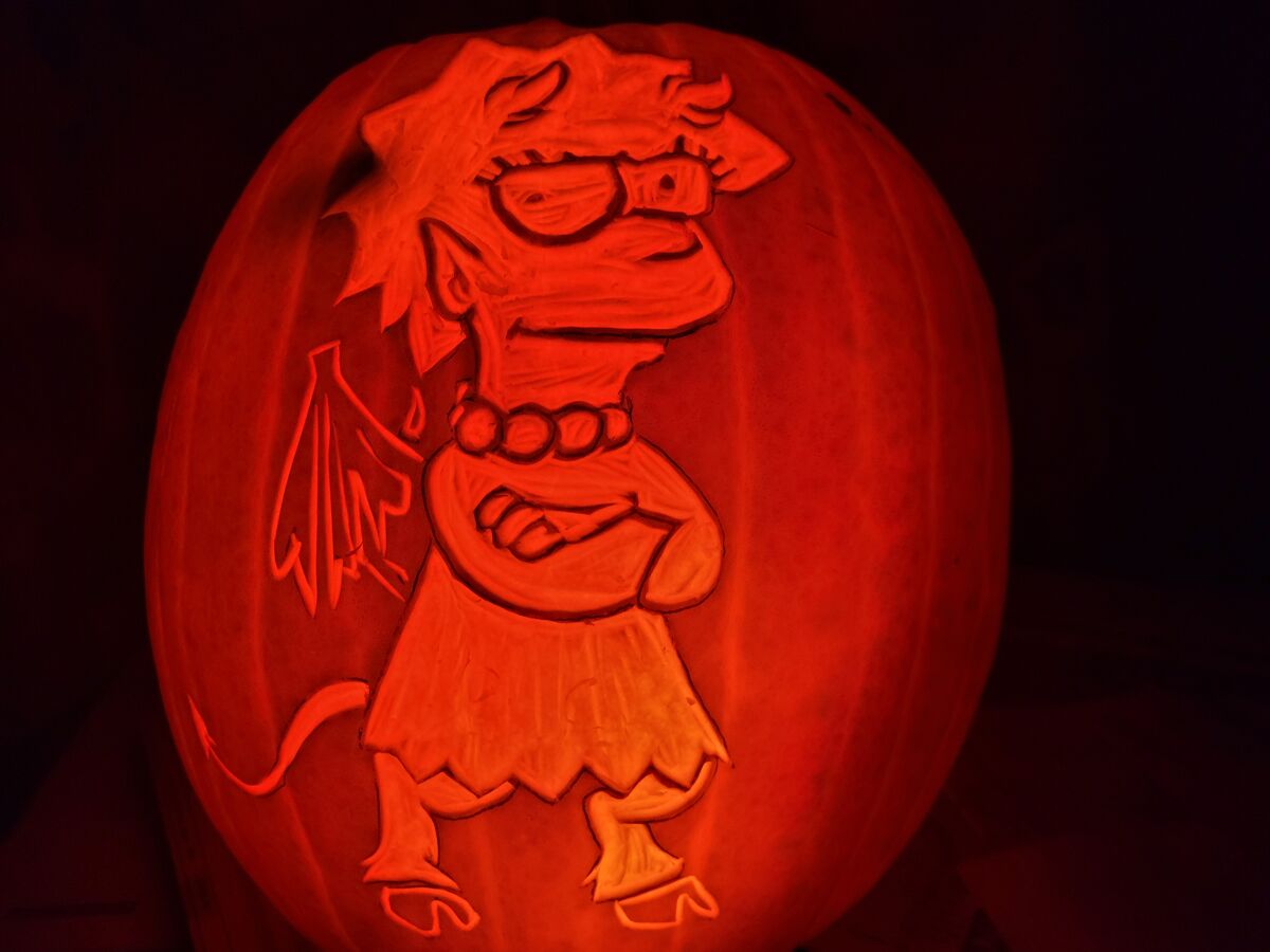 A pumpkin carved with Lisa Simpson from The Simpsons.